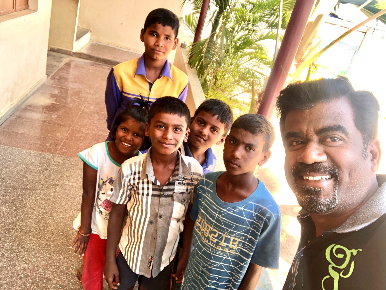 Children smiling together during a community visit