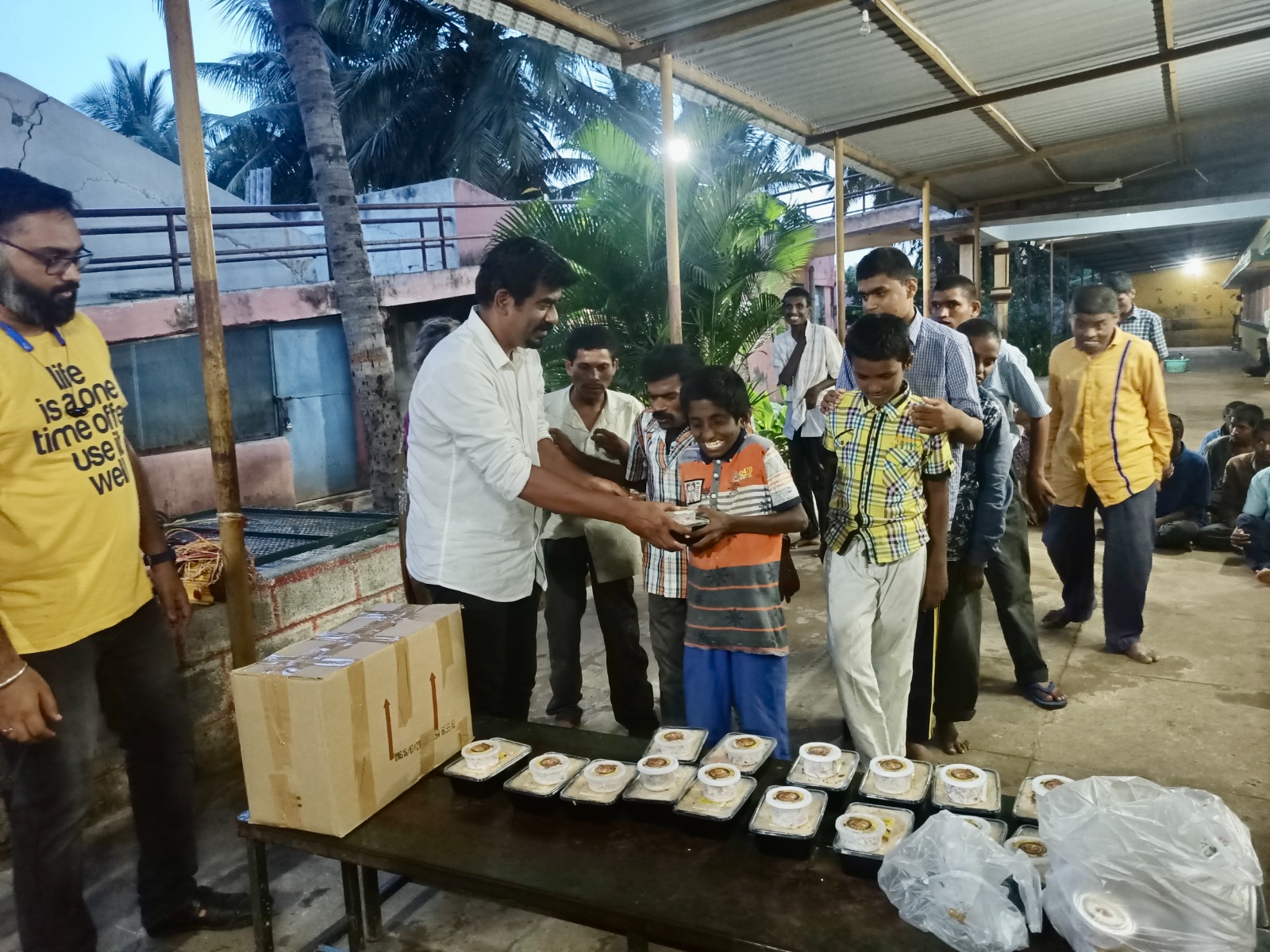 Volunteers distributing packed meals to children and families