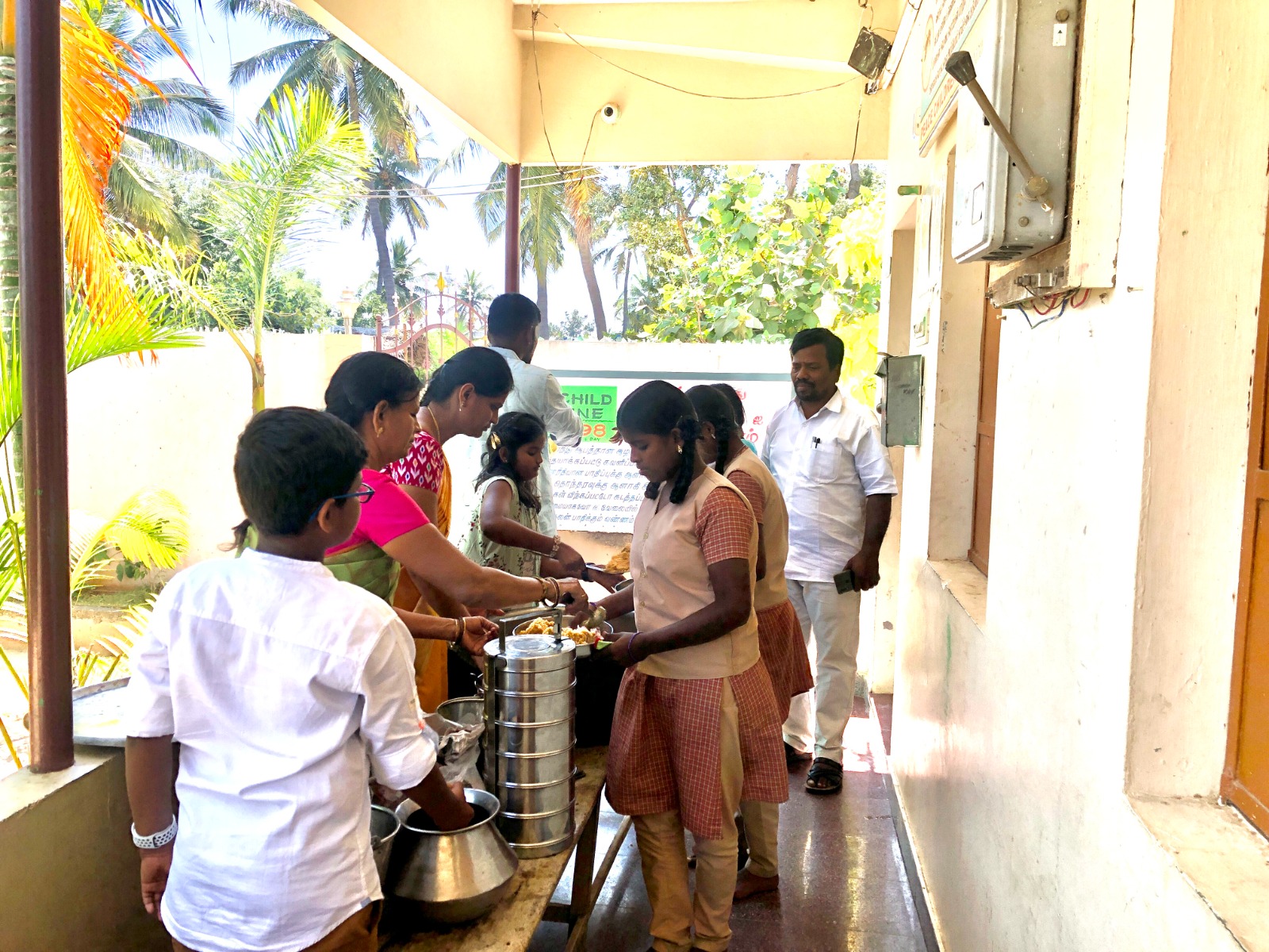 Volunteers serving food to school children